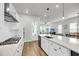 Bright, open kitchen features stainless appliances, white cabinets, stone countertops, and hardwood flooring at 2844 Pinelog Ln, Johns Island, SC 29455