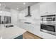 Modern kitchen features stainless steel appliances, white cabinetry, stone countertops, and hardwood flooring at 2844 Pinelog Ln, Johns Island, SC 29455