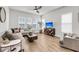 Spacious living room with a ceiling fan, neutral tones, and plenty of natural light from large windows at 2844 Pinelog Ln, Johns Island, SC 29455