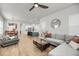 Open-concept living room with hardwood floors and seamless access to the kitchen and dining area at 2844 Pinelog Ln, Johns Island, SC 29455