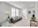 Bright and airy living room featuring neutral tones, comfortable seating, and natural light from the window at 2844 Pinelog Ln, Johns Island, SC 29455