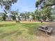 A park area with picnic tables, green grass, and a playground area including benches and play structures at 2844 Pinelog Ln, Johns Island, SC 29455