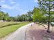 View of a pond along a gravel walking trail with green grass and trees at 2844 Pinelog Ln, Johns Island, SC 29455
