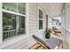 Relaxing front porch with lounge chairs, potted plant, and a view of the neighborhood at 2844 Pinelog Ln, Johns Island, SC 29455