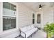 Comfortable front porch with outdoor seating, neutral decor, and pleasant lighting at 2844 Pinelog Ln, Johns Island, SC 29455