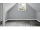 Finished attic area, with neutral paint, carpet and featuring a window with bright light and trim at 300 Greens Ct, Goose Creek, SC 29445
