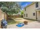 This backyard includes a paver patio, a fire pit, and is enclosed with a wooden fence at 300 Greens Ct, Goose Creek, SC 29445