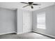 Neutral painted bedroom featuring a ceiling fan, a closet, trim, and window allowing plenty of natural light at 300 Greens Ct, Goose Creek, SC 29445