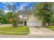 Charming two-story home featuring a well-manicured lawn, mature trees, and an attached two car garage at 300 Greens Ct, Goose Creek, SC 29445