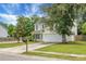 Home exterior features a well-kept lawn, a cozy front porch, and an attached two-car garage at 300 Greens Ct, Goose Creek, SC 29445