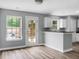 Bright kitchen with wood flooring, granite countertops, and access to the backyard at 300 Greens Ct, Goose Creek, SC 29445