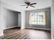 Bright living room featuring wood floors, large window with curtains, and neutral paint at 300 Greens Ct, Goose Creek, SC 29445