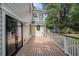 Backyard deck leads to a balcony and is surrounded by trees, creating a natural and private outdoor space at 3002 Edenvale Rd, Johns Island, SC 29455