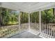 A balcony surrounded by columns looks out at a lush forest full of trees at 3002 Edenvale Rd, Johns Island, SC 29455