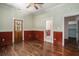Bedroom featuring hardwood floors, a door, and an entrance to the bathroom with views of the rest of the home at 3002 Edenvale Rd, Johns Island, SC 29455