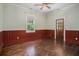 Spacious bedroom featuring hardwood floors, ceiling fan, and natural light from a window and door at 3002 Edenvale Rd, Johns Island, SC 29455