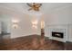 Bedroom featuring a decorative fireplace, custom sconces and hardwood floors at 3002 Edenvale Rd, Johns Island, SC 29455