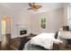 Bright bedroom features a decorative fireplace, ceiling fan and large windows at 3002 Edenvale Rd, Johns Island, SC 29455
