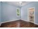 Bedroom featuring shiplap walls, hardwood floors and a custom ensuite bathroom at 3002 Edenvale Rd, Johns Island, SC 29455