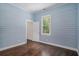 Bedroom featuring shiplap walls, hardwood floors and a large window at 3002 Edenvale Rd, Johns Island, SC 29455