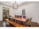 Elegant dining room featuring a large wooden table, rustic bench, and stylish chandelier at 3002 Edenvale Rd, Johns Island, SC 29455