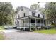 Charming two-story home featuring a spacious wrap-around porch and accessible ramp entry at 3002 Edenvale Rd, Johns Island, SC 29455