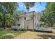 Charming home with an upper balcony and large deck surrounded by trees on a large property at 3002 Edenvale Rd, Johns Island, SC 29455