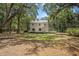 Exterior of house from afar with lush tree canopy at 3002 Edenvale Rd, Johns Island, SC 29455
