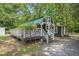 Exterior view of a charming outbuilding with a green roof and white trim at 3002 Edenvale Rd, Johns Island, SC 29455