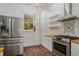 Bright kitchen featuring white cabinets, stainless steel appliances and brick floors at 3002 Edenvale Rd, Johns Island, SC 29455