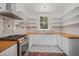 Bright kitchen featuring white cabinets, butcher block counters and a stainless steel range at 3002 Edenvale Rd, Johns Island, SC 29455