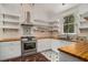 Charming kitchen featuring butcher block countertops, stainless steel appliances, and custom backsplash at 3002 Edenvale Rd, Johns Island, SC 29455