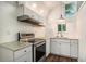 Modern kitchenette with stainless steel appliances, white cabinets, and hardwood floors at 3002 Edenvale Rd, Johns Island, SC 29455