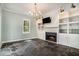 Living room with custom fireplace with built-ins, stone floors and tons of natural light at 3002 Edenvale Rd, Johns Island, SC 29455