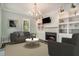 Inviting living room features a cozy fireplace, built-in shelving, and great natural light at 3002 Edenvale Rd, Johns Island, SC 29455