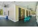 Exterior side porch with outdoor seating and black trim wooden doors at 3002 Edenvale Rd, Johns Island, SC 29455