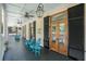 Inviting porch with rocking chairs, ceiling fans, wooden doors, and views of the surrounding landscape at 3002 Edenvale Rd, Johns Island, SC 29455