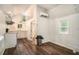 Bright room with hardwood floors, a modern AC unit, and a partial kitchen area at 3002 Edenvale Rd, Johns Island, SC 29455