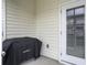 This back patio includes a Blackstone grill and a door with window leading inside at 312 Silverdrop St, Goose Creek, SC 29445