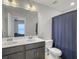 Bathroom with a double sink vanity with a white countertop and dark cabinets and a large mirror at 312 Silverdrop St, Goose Creek, SC 29445
