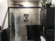 Modern bathroom featuring a tiled shower with black trim, a shower niche, and a black cabinet at 312 Silverdrop St, Goose Creek, SC 29445