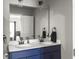Bathroom with a double sink vanity with a white countertop and blue cabinets and a large mirror at 312 Silverdrop St, Goose Creek, SC 29445