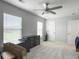 A bright bedroom with two windows and a dresser with neutral paint throughout the space at 312 Silverdrop St, Goose Creek, SC 29445