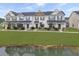 A picturesque townhouse community overlooks a serene pond and lush green lawns at 312 Silverdrop St, Goose Creek, SC 29445