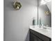 Well-lit half bathroom featuring a modern vanity, stylish fixtures, and decorative shelving at 312 Silverdrop St, Goose Creek, SC 29445