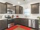 Modern kitchen with stainless steel appliances, including a microwave and dishwasher, and dark cabinets at 312 Silverdrop St, Goose Creek, SC 29445