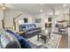 Open-concept living area with a staircase, comfortable seating, and hardwood floors at 312 Silverdrop St, Goose Creek, SC 29445