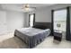 This bedroom features a ceiling fan, two windows with blinds, and neutral-toned walls and carpet at 312 Silverdrop St, Goose Creek, SC 29445