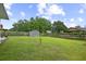 Spacious backyard featuring a well-maintained lawn, wooden fence, and convenient storage shed at 313 Janice St, Goose Creek, SC 29445