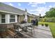 Back deck features table and chairs, and outdoor grilling area with a view of the backyard at 313 Janice St, Goose Creek, SC 29445